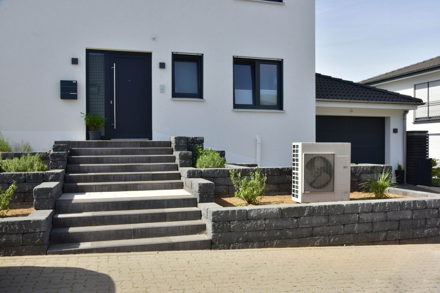 Air conditioner, Air-Air Heat Pump for Heating and hot Water in Front of an Residential Building
